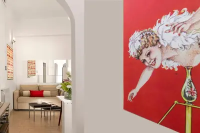 a living room with a painting of an angel on the wall at Grotte Apartment near Campo dé Fiori in Rome