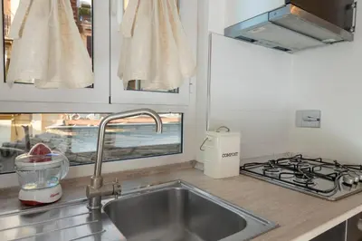 a kitchen with a sink and a stove at Grotte Apartment near Campo dé Fiori in Rome