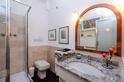 a bathroom with a sink and a toilet and a shower at Amazing Penthouse with Terrace by Caracalla in Rome
