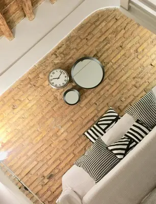 a living room with a clock and a couch at The heart of Trastevere in Rome