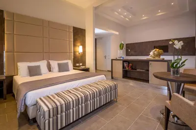 a bedroom with a bed and a table and a couch at Hearth Hotel in Rome