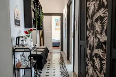 a hallway with a room with a black and white floor at St. Peter Central Rooms B&B in Rome