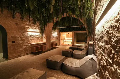 a living room with couches and a brick wall at Rome Times Hotel in Rome