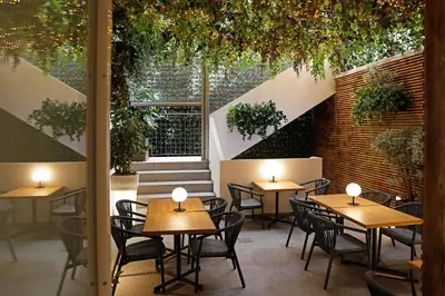 a restaurant with tables and chairs and a large window at Rome Times Hotel in Rome
