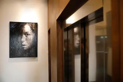 a painting of a woman hanging on a wall at Rome Times Hotel in Rome