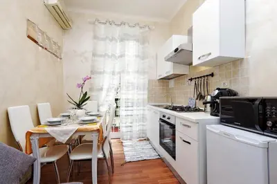 a kitchen with a table and a dining room at AL Holiday Home in Rome