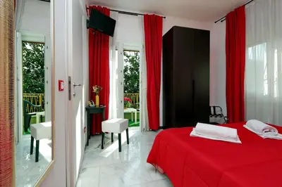 a bedroom with a red bed and red curtains at I Pini di Roma - Rooms & Suites in Rome