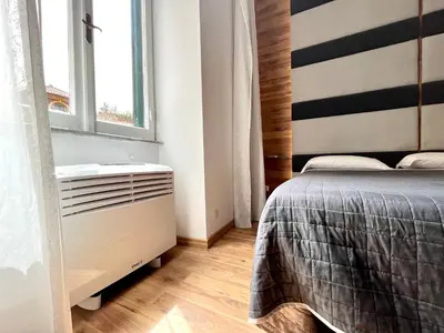 a bedroom with a bed and a window at I Pini di Roma - Rooms & Suites in Rome