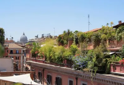 a city with plants on the roofs of buildings at Frattina Apartments in Rome