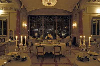a dining room with white tables and chairs and candles at Villa Laetitia in Rome