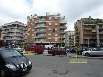 a parking lot with cars parked in front of tall buildings at Anton Inn Rome Cornelia Apartment in Rome