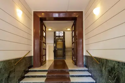 a hallway of a building with stairs and a door at Residenza Dorò- 24x7 Check-in in Rome
