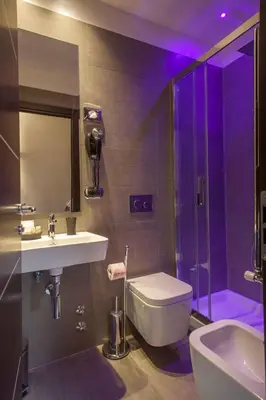 a bathroom with a sink and a toilet and a shower at Residenza Dorò- 24x7 Check-in in Rome