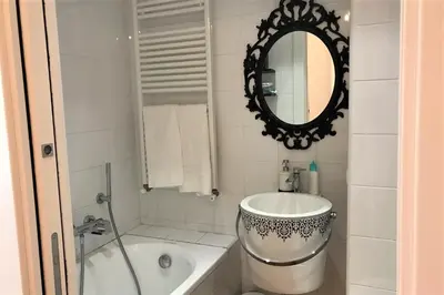 a bathroom with a tub and a sink and a mirror at Domus Caecilia - via Cola di Rienzo in Rome