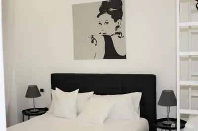 a bedroom with a bed and a painting on the wall at Domus Caecilia - via Cola di Rienzo in Rome