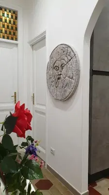 a sculpture of a face on a wall in a room at Casa Ferrari Testaccio e Trastevere Wi-Fi free in Rome
