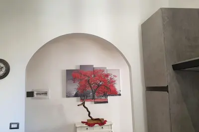 a painting of a red tree on a wall at Casa Ferrari Testaccio e Trastevere Wi-Fi free in Rome