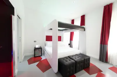 a bedroom with a bunk bed with red accents at 7 Inn Spanish Steps in Rome