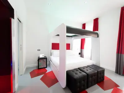 a bedroom with a white bed and red accents at 7 Inn Spanish Steps in Rome