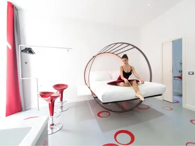 a woman sitting on a bed in a room at 7 Inn Spanish Steps in Rome