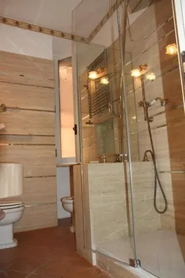 a bathroom with a shower and a toilet at Colosseo Smart Flat in Rome