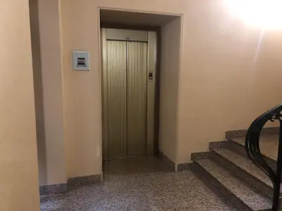 a hallway with a door and stairs in a building at Colosseo Smart Flat in Rome