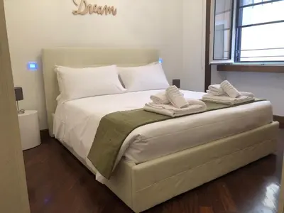 a bedroom with a bed with two towels on it at Colosseo Smart Flat in Rome