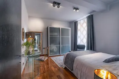 a bedroom with a bed and a table and a mirror at Vic Colosseo, Centro Storico Roma in Rome