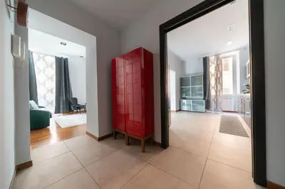 a red cabinet in a living room with a mirror at Vic Colosseo, Centro Storico Roma in Rome