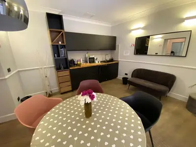 a living room with a table with a vase of flowers on it at Holidays Suites Navona in Rome