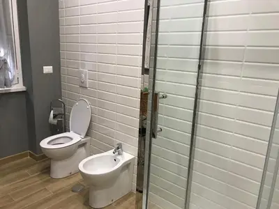 a bathroom with a toilet and a sink and a shower at Da Nonna Maria in Rome