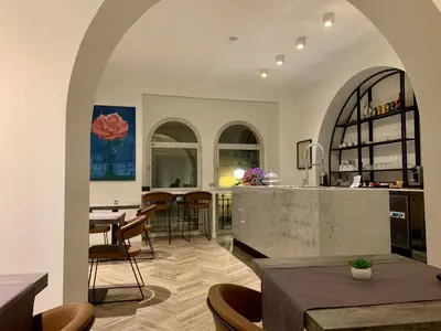 a kitchen and dining room with a table and chairs at Florea Palace in Rome