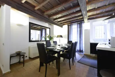 a dining room with a table and black chairs at Easydomus Rome in Rome