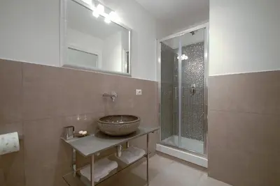 a bathroom with a bowl sink and a shower at Easydomus Rome in Rome