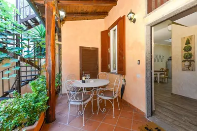 a patio with a table and chairs on a balcony at Easydomus Rome in Rome