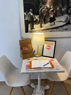 a table with a lamp and a book on it at Art Atelier Vaticano Guest House in Rome