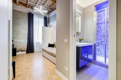 a bedroom with a bed and a sink in a room at Tankara Suite in Rome