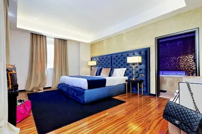 a hotel room with a bed and a couch at Spanish Diamond Luxury Suites & Jacuzzi in Rome