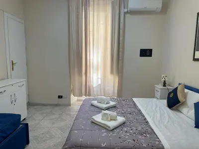a bedroom with a bed with two towels on it at welcome Termini in Rome