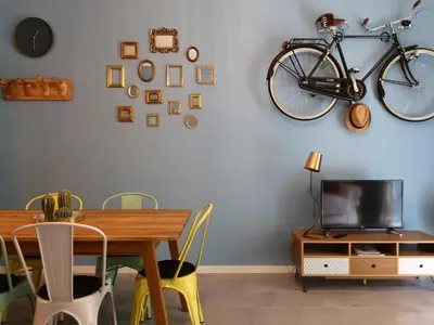 a dining room with a table and a bike hanging on the wall at Interno Otto in Rome