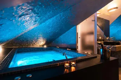 a large swimming pool in a bathroom with a blue ceiling at SuiteFrattini Private Spa in Rome