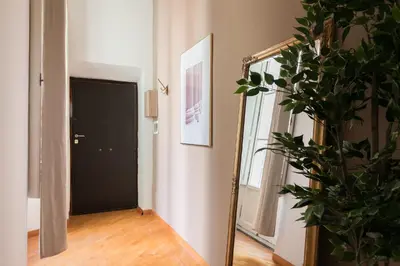a hallway with a mirror and a potted plant at VENETO AVENUE in Rome