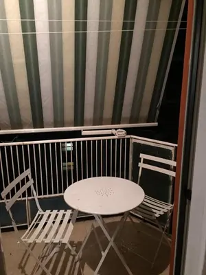 a table and two chairs on a balcony at Roma Apartment in Rome
