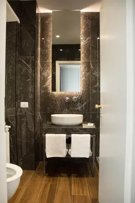 a bathroom with a sink and a mirror at Unicum Roma Suites in Rome