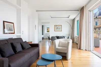 a living room with a couch and a table at Penthouse Rome Capitol in Rome