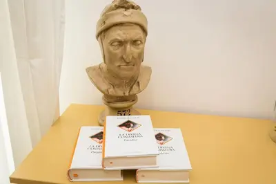 a bust of a man sitting on a table with two books at Lovely New Apartament, Viale Trastevere in Rome