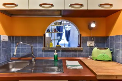 a kitchen counter with a sink and a window at Trastevere Queen in Rome