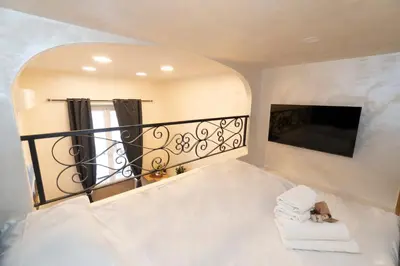 a room with a balcony with a tv and towels at POPOLO PEN 56 Apartament in Rome