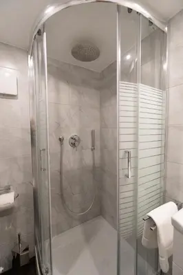 a shower with a glass door in a bathroom at POPOLO PEN 56 Apartament in Rome