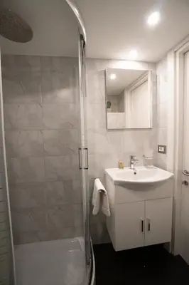 a bathroom with a shower and a sink and a mirror at POPOLO PEN 56 Apartament in Rome